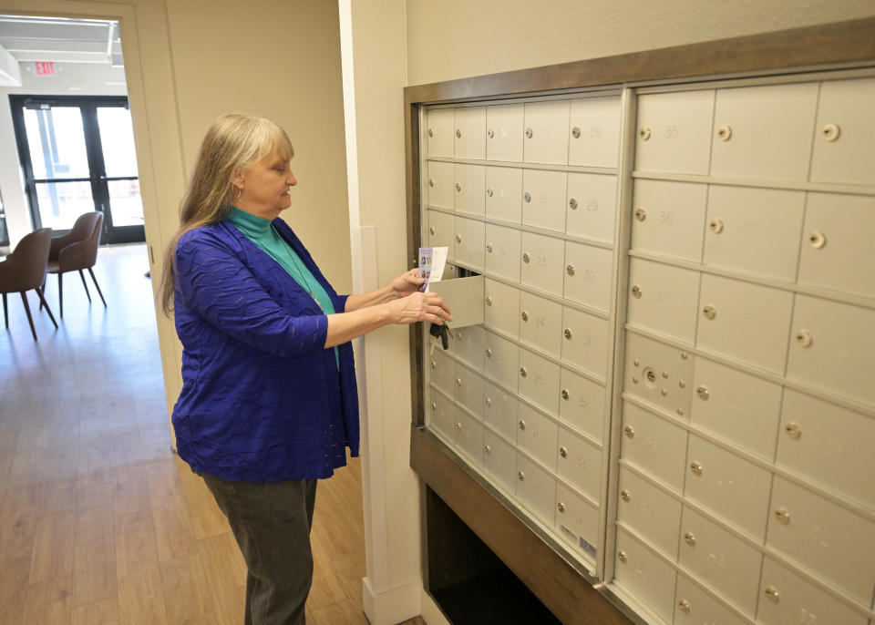 BOULDER, COLORADO - FEBRUARY 27: Rebecca Herr checks her mail box in the lobby of Canyon Pointe Apartments where she has a rent controlled subsidized apartment in Boulder, Colorado on February 27, 2024. (Photo by RJ Sangosti/MediaNews Group/The Denver Post via Getty Images)