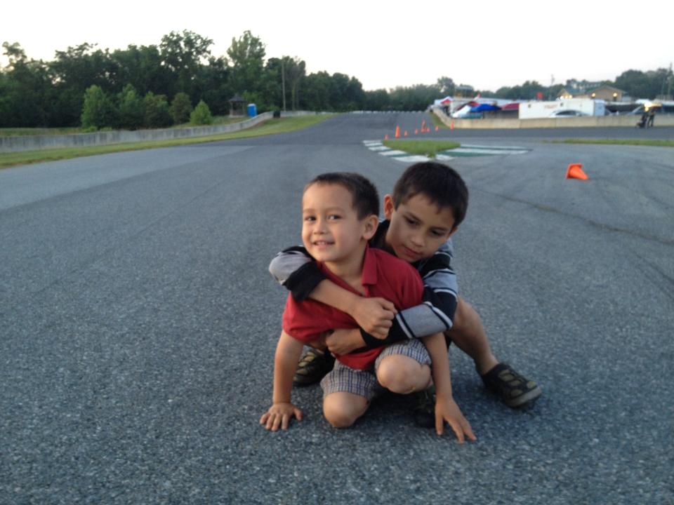 Alex Fisher gets a hug from his big brother, Ben Fisher, at the Summit Point raceway in West Virginia in 2012. They are the sons of Jake Fisher, an automotive expert at Consumer Reports. Alex Fisher helped discover a safety flaw in the trunk of a vehicle.