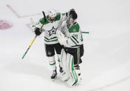 Dallas Stars' Alexander Radulov (47) and goalie Anton Khudobin (35) celebrate their 1-0 win over the Vegas Golden Knights after an NHL Western Conference final playoff hockey game, in Edmonton, Alberta, Sunday, Sept. 6, 2020. (Jason Franson/The Canadian Press via AP)