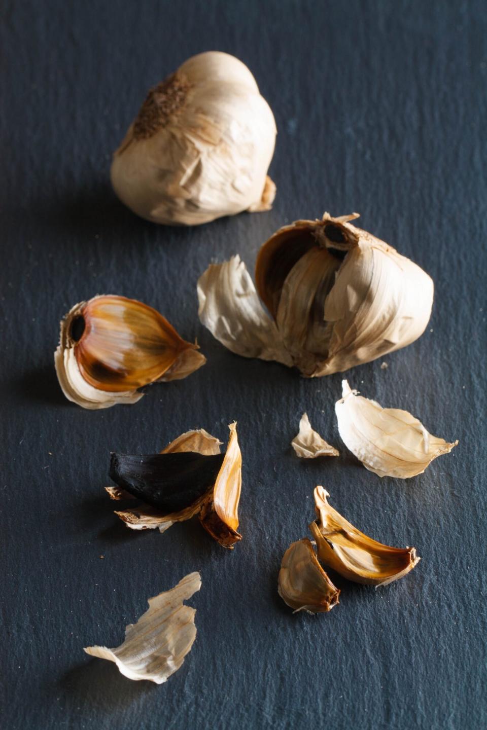 cloves and heads of black garlic