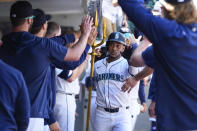Seattle Mariners' Jorge Polanco celebrates with a trident in the dugout after hitting a two-run home run against the Chicago Cubs during the sixth inning of a baseball game Sunday, April 14, 2024, in Seattle. (AP Photo/Lindsey Wasson)