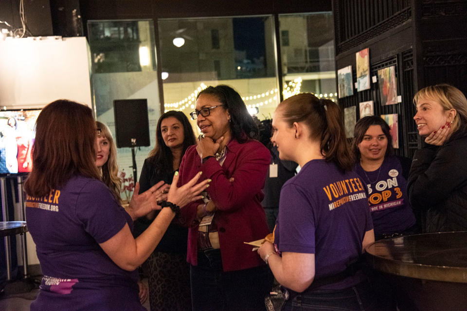 Advocate Darci McConnell (center) and supporters convene ahead of Proposal 3 results on Nov. 8, 2022, in Detroit.