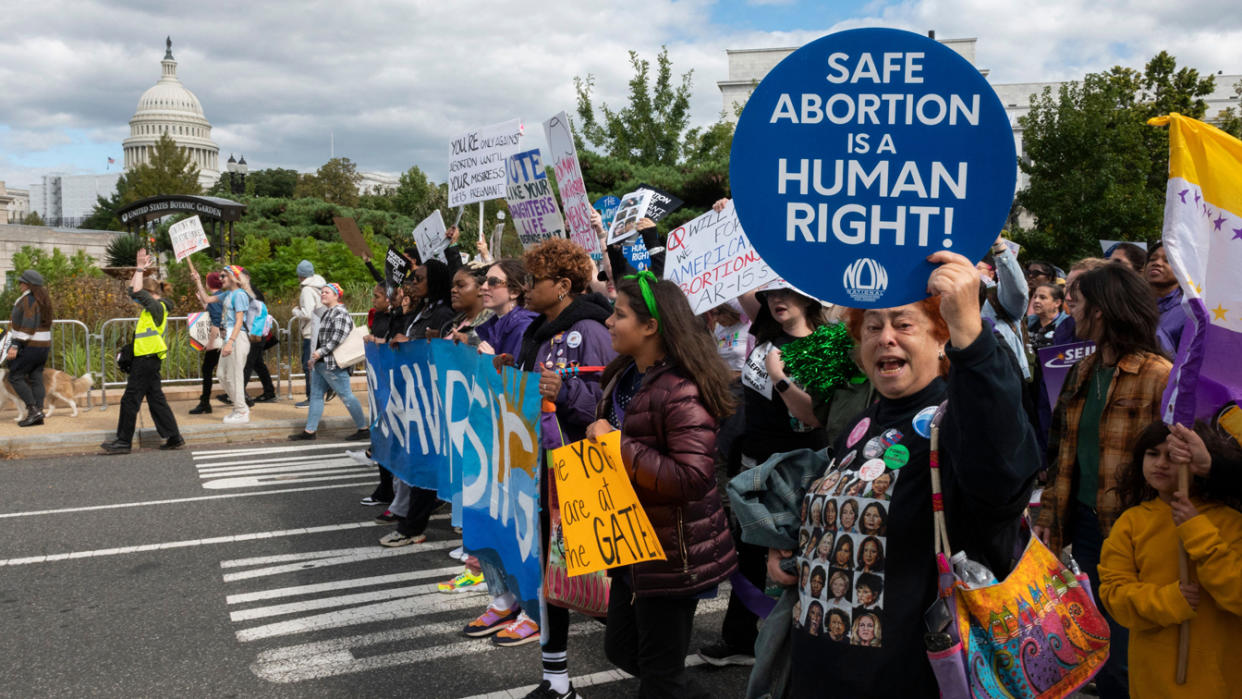 Pro-abortion rights demonstrators march past the Capitol 