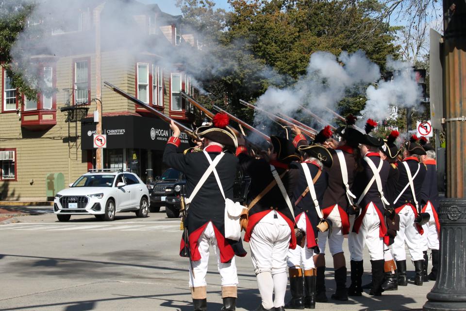 The Artillery Company of Newport fires their muskets in salute to the start of Festa Italiana on Monday.