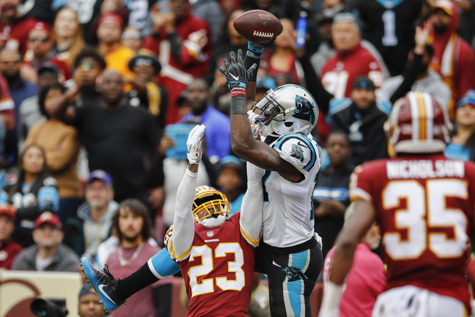 Carolina Panthers wide receiver Devin Funchess (17) pulls in a touchdown pass under pressure from Washington Redskins cornerback Quinton Dunbar (23) during the first half of an NFL football game, Sunday, Oct. 14, 2018, in Landover, Md. (AP Photo/Patrick Semansky)