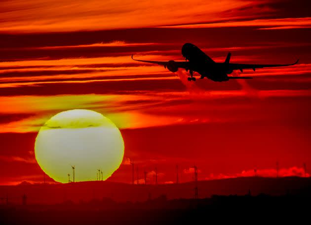 An aircraft takes off at the international airport as the sun sets in Frankfurt, Germany, on Oct. 4.  (Photo: Michael Probst via AP)