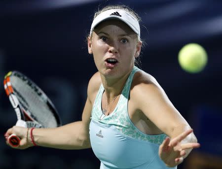 Caroline Wozniacki of Denmark returns the ball to Simona Halep of Romania during their women's singles tennis semi-final match at the WTA Dubai Tennis Championships February 20, 2015. REUTERS/Ahmed Jadallah