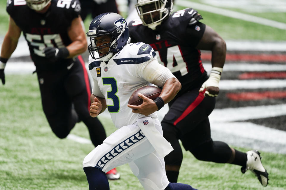 Seattle Seahawks quarterback Russell Wilson (3) runs for a first down against the Atlanta Falcons during the first half of an NFL football game, Sunday, Sept. 13, 2020, in Atlanta. (AP Photo/John Bazemore)