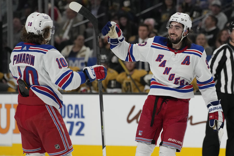 New York Rangers center Mika Zibanejad (93), right, celebrates after scoring against the Vegas Golden Knights for the second time during the third period of an NHL hockey game Wednesday, Dec. 7, 2022, in Las Vegas. (AP Photo/John Locher)
