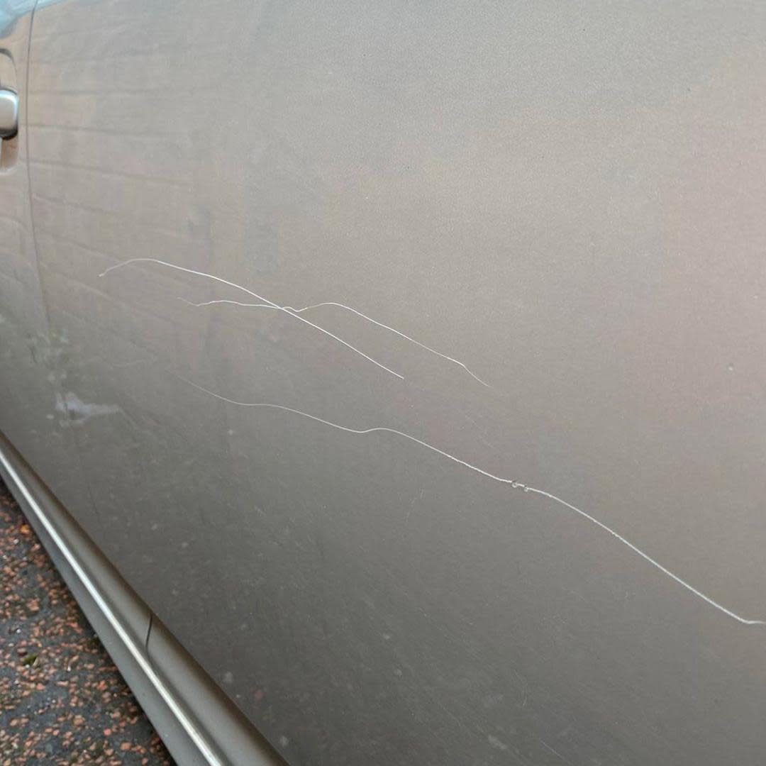 Scrapes on the side of silver-coloured car