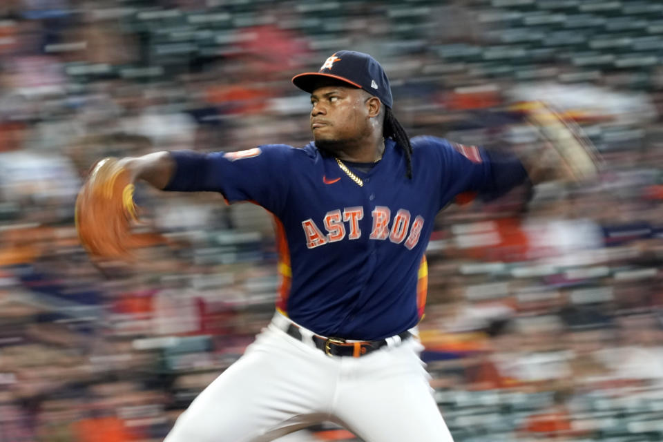 In this photo taken with a slow shutter speed, Houston Astros starting pitcher Framber Valdez throws against the Oakland Athletics during the second inning of a baseball game Sunday, Sept. 18, 2022, in Houston. (AP Photo/David J. Phillip)