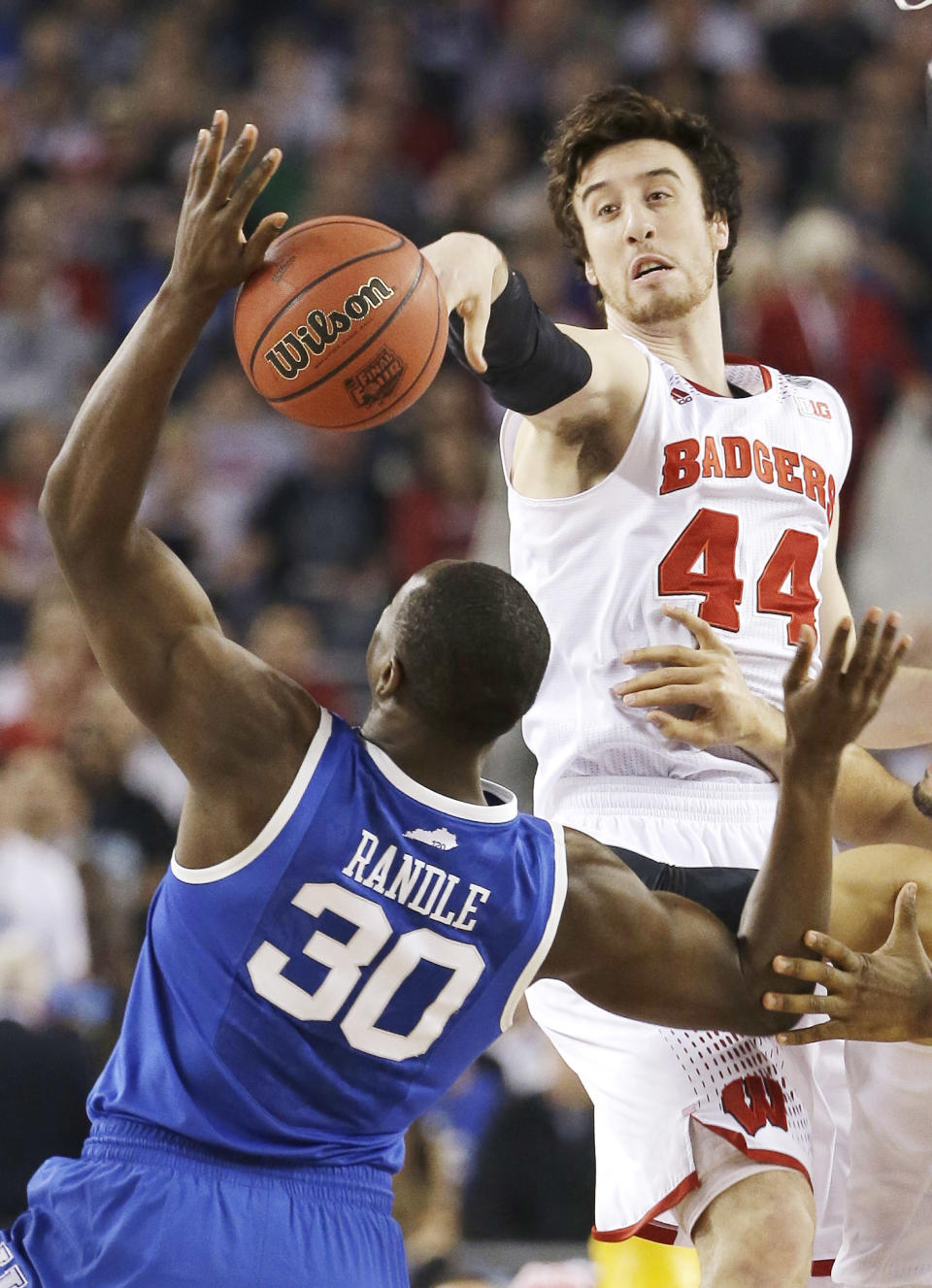 Wisconsin forward Frank Kaminsky (44) and Kentucky forward Julius Randle (30) tip the ball to begin their NCAA Final Four tournament college basketball semifinal game Saturday, April 5, 2014, in Arlington, Texas. (AP Photo/David J. Phillip)