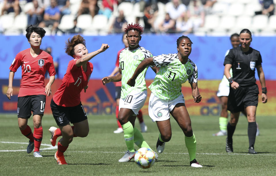 South Korea's Jung Seol-bin, left, challenges Nigeria's Chinaza Uchendu during the Women's World Cup Group A soccer match between Nigeria and South Korea in Grenoble, France, Wednesday June 12, 2019.(AP Photo/Laurent Cipriani)