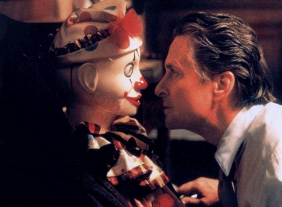 Michael Douglas looking at a clown