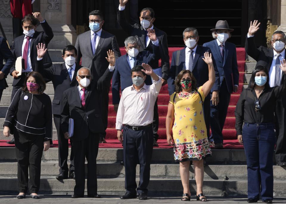 FILE - Peruvian President Pedro Castillo, center front, waves alongside his new cabinet outside the government palace as his cabinet leaves for Congress to ask lawmakers for a vote of confidence, in Lima, Peru, March 8, 2022. Castillo swore in the fourth Cabinet of his half year in office amid criticism for his poor previous choices for ministers and even calls by his rivals to step down. (AP Photo/Martin Mejia, File)