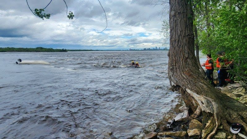 Ottawa Fire Services posted this photo of a rescue on Tuesday. A man was stuck in a rope that was used to attach the capsized boat to the shore, according to Ottawa fire.  (Ottawa Fire Services/X - image credit)