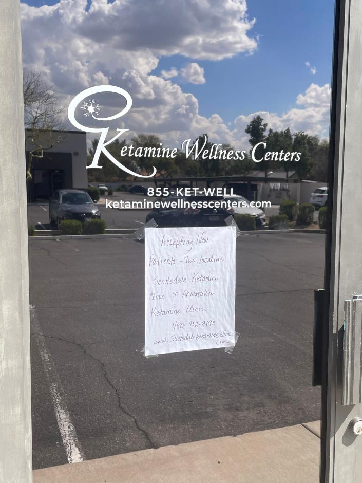 Ketamine Wellness Centers in Gilbert shown on March 17, 2023, has a handwritten note on the door referring customers to other ketamine clinics in the Phoenix area. The company closed its clinics in nine states, including Arizona.