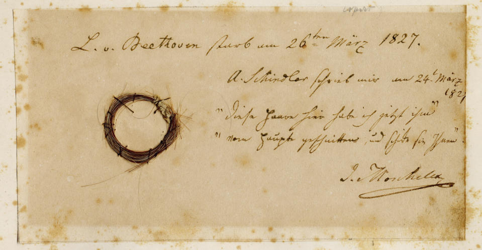 This photo provided by the Ira F. Brilliant Center for Beethoven Studies, San Jose State University in March 2023, shows the Moscheles Lock, from composer Ludwig van Beethoven, with an inscription by former owner Ignaz Moscheles. Hundreds of years after Beethoven's death, researchers have pulled DNA from strands of his hair — and found clues about what killed him, according to a study published Wednesday March 22, 2023. (Ira F. Brilliant Center for Beethoven Studies, San Jose State University via AP)