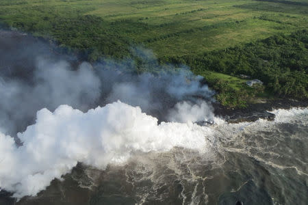 Hot lava entering the Pacific Ocean creates a dense white plume called 'laze', short for lava haze, in southeast of Pahoa, during ongoing eruptions of the Kilauea Volcano in Hawaii, U.S., May 20, 2018. Picture taken May 20, 2018. USGS/Handout via REUTERS