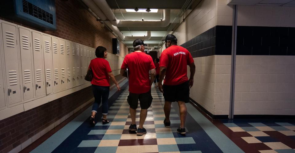 From left, Janie Ruiz, Rudy Landeros and Rodrick Brown walk the halls of their old high school, the former Johnston High, ahead of their 50-year reunion later this year. The East Austin school building, now home to the Liberal Arts and Science Academy, has been through many changes in the years since the class of 1973 graduated, but the lockers and tile in this hallway remain the same.