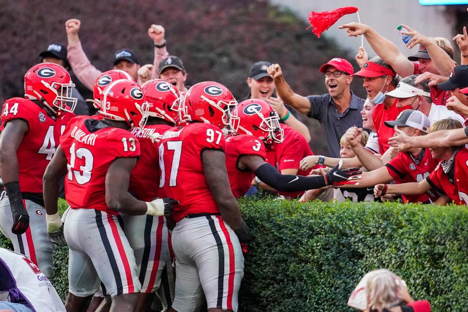 Oct 10, 2020; Athens, Georgia, USA; Georgia Bulldogs players react with fans in the end zone after linebacker Monty Rice (32) (in crowd of players) returns a  fumble for a touchdown against the Tennessee Volunteers during the second half at Sanford Stadium. Mandatory Credit: Dale Zanine-USA TODAY Sports 