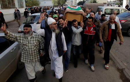 Relatives carry the coffin of British-Algerian journalist Mohamed Tamalt, British-Algerian journalist who had died six months after staging a hunger strike in Algiers over his detention for publishing articles seen as offensive to President Abdelaziz Bouteflika, during his funeral in Algiers, Algeria December 12, 2016. REUTERS/ Ramzi Boudina