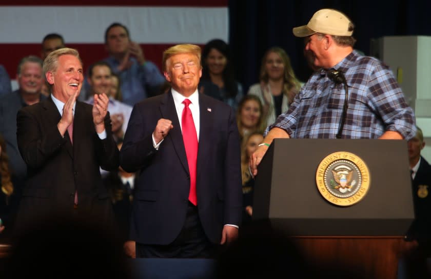 House Republican leader Kevin McCarthy and President Donald Trump react to farmer Larry Starrh praise the President's efforts towards farmers. The president who visited Bakersfield to sign his administration's reworking of environmental regulations that will direct more of the stateÕs water to farmers and other agriculture interests in the Central Valley. (Alex Horvath / The Californian)