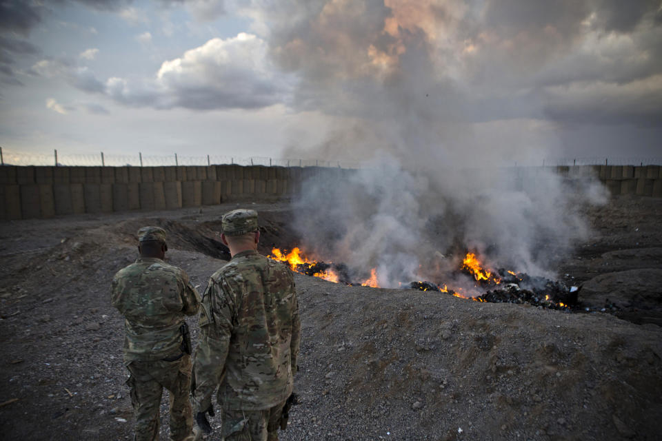 U.S. Army soldiers watch garbage burn in a burn-pit at Forward Operating Base Azzizulah in Kandahar Province, Afghanistan, in 2013. (Andrew Burton / Reuters file)