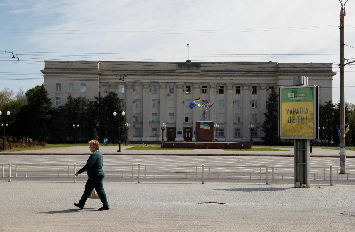 A woman walks through the war-torn city of Kherson earlier in September. The city was targeted by 24 missiles in the past day, says Ukraine (REUTERS/Bernadett Szabo)