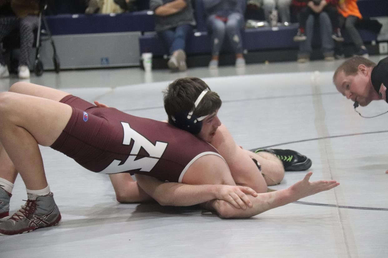 Shawnee's Spencer Rochelle prepares to pin Ada's Will Johnson in the 170-pound match Tuesday night at the Stucker Complex.