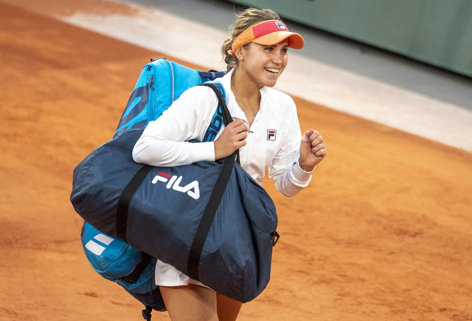 A smiling Sofia Kenin leaves the court after her victory against Petra Kvitova at the French Open.