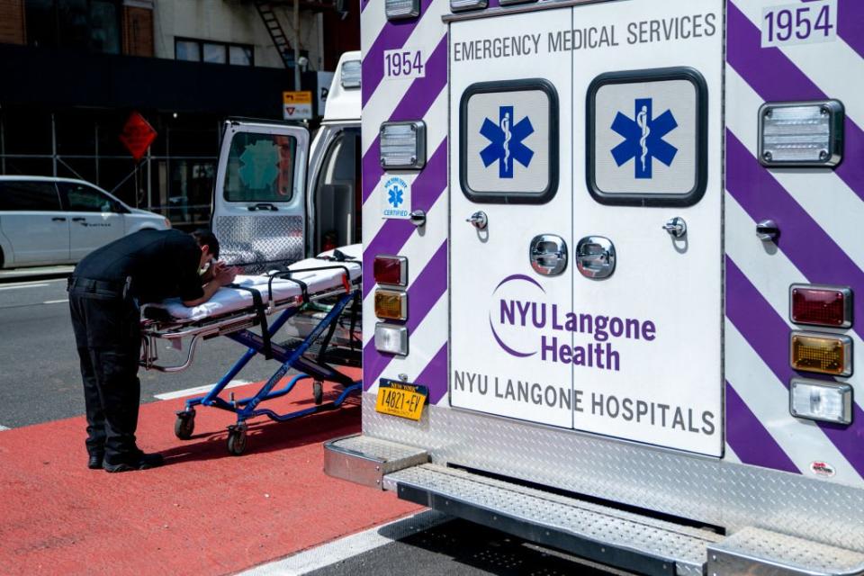 <div class="inline-image__caption"><p>A EMT takes a moment in front of NYU Langone Hospital on April 7.</p></div> <div class="inline-image__credit">David Dee Delgado/Getty</div>