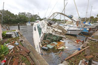 <p><strong>Palm Shores</strong><br>One of eight sunken boats at Sundance Marine in Palm Shores, Fla. on Sept. 11, 2017. Debris from sunken boats and docks washed over the seawall onto the land as Hurricane Irma winds blew from the east. (Photo: Red Huber/Orlando Sentinel/TNS via Getty Images) </p>