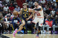Indiana Pacers guard Chris Duarte (3) drives past Miami Heat guard Max Strus (31) during the first half of an NBA basketball game, Wednesday, Feb. 8, 2023, in Miami. (AP Photo/Wilfredo Lee)