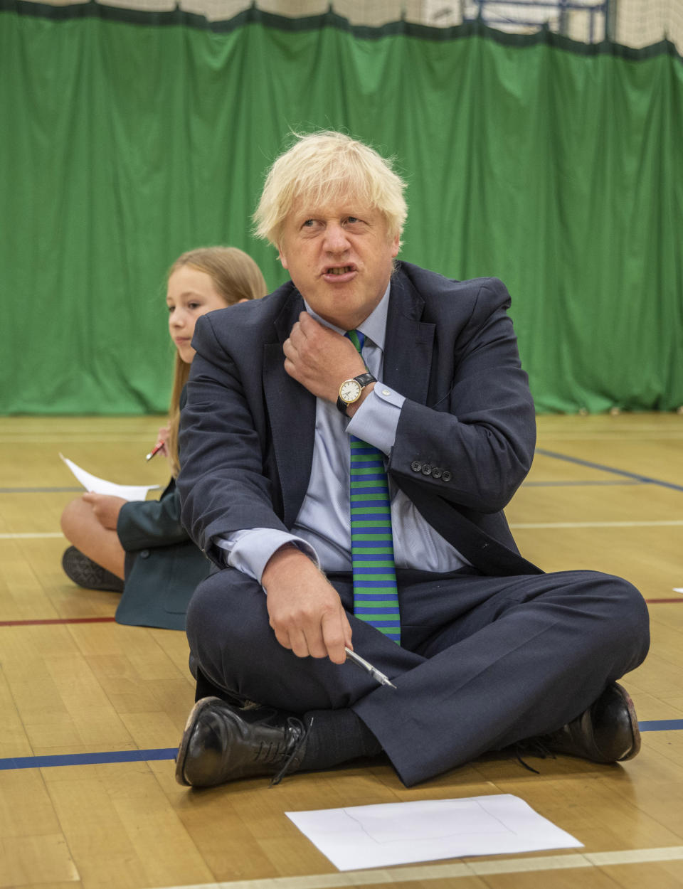 Prime Minister Boris Johnson with Olivia Stokes in the gym taking part in a getting to know you induction session with year sevens as he tours Castle Rock school, Coalville, in the east Midlands.