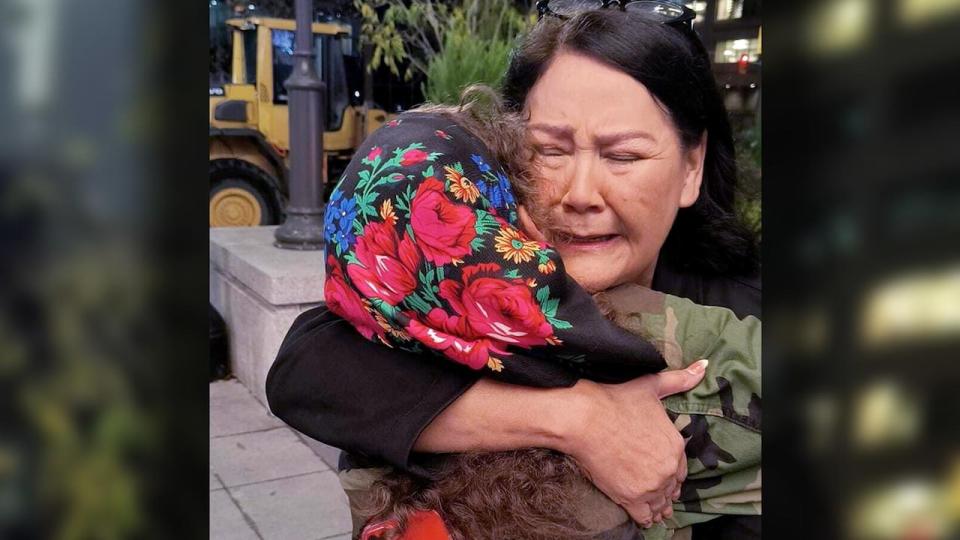 AMC Grand Chief Cathy Merrick embraces Cambria Harris on Tuesday night upon hearing NDP Leader Wab Kinew will become Manitoba's next premier. Police believe Harris's mother Morgan Harris was among four women killed by an alleged serial killer and that her remains are located at Prairie Green landfill.