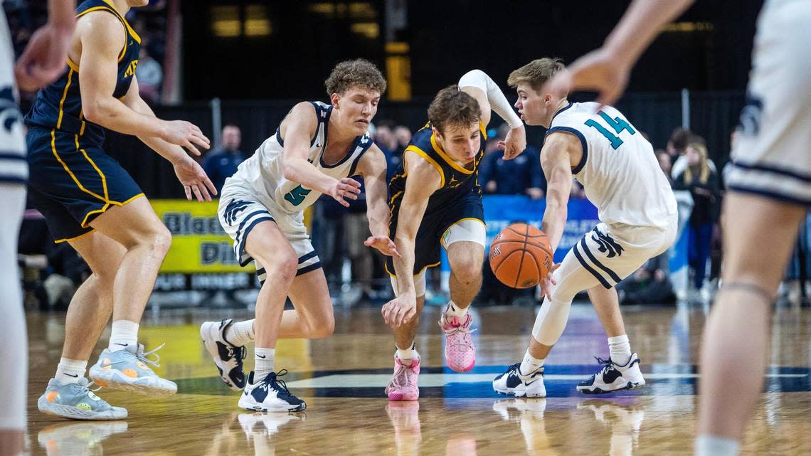 Meridian senior Josh Christensen, center, fights for a loose ball Saturday in the 5A boys basketball state championship.