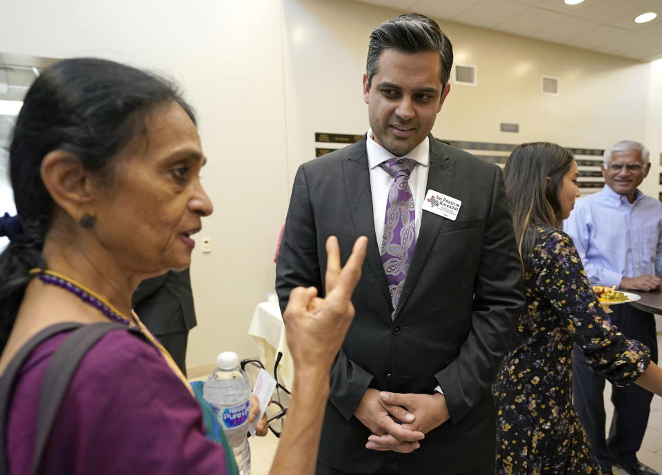 In this Sunday, July 29, 2018, photo, Thara Narasimhan, left, talks with Democrat for Congress candidate Sri Kulkarni during a fundraiser in Houston. Narasimhan, who hosts an Hindu radio program in Houston, has already given $1,200 to the Democrat running against Republican U.S. Rep. Pete Olson. (AP Photo/David J. Phillip)