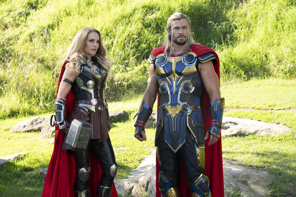 This image released by Marvel Studios shows Natalie Portman, left, and Chris Hemsworth in a scene from "Thor: Love and Thunder." (Jasin Boland/Marvel Studios-Disney via AP)