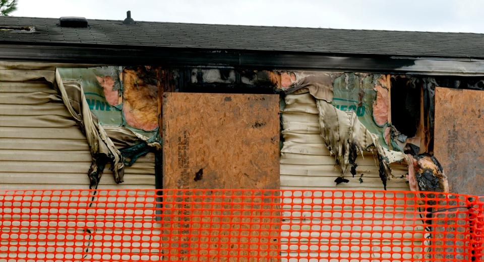 This photo taken April 7, 2019, shows melted vinyl siding hanging off the side of a trailer home at 14 Cypress Court in the Timberline Mobile Home Park northeast of Goodfield.