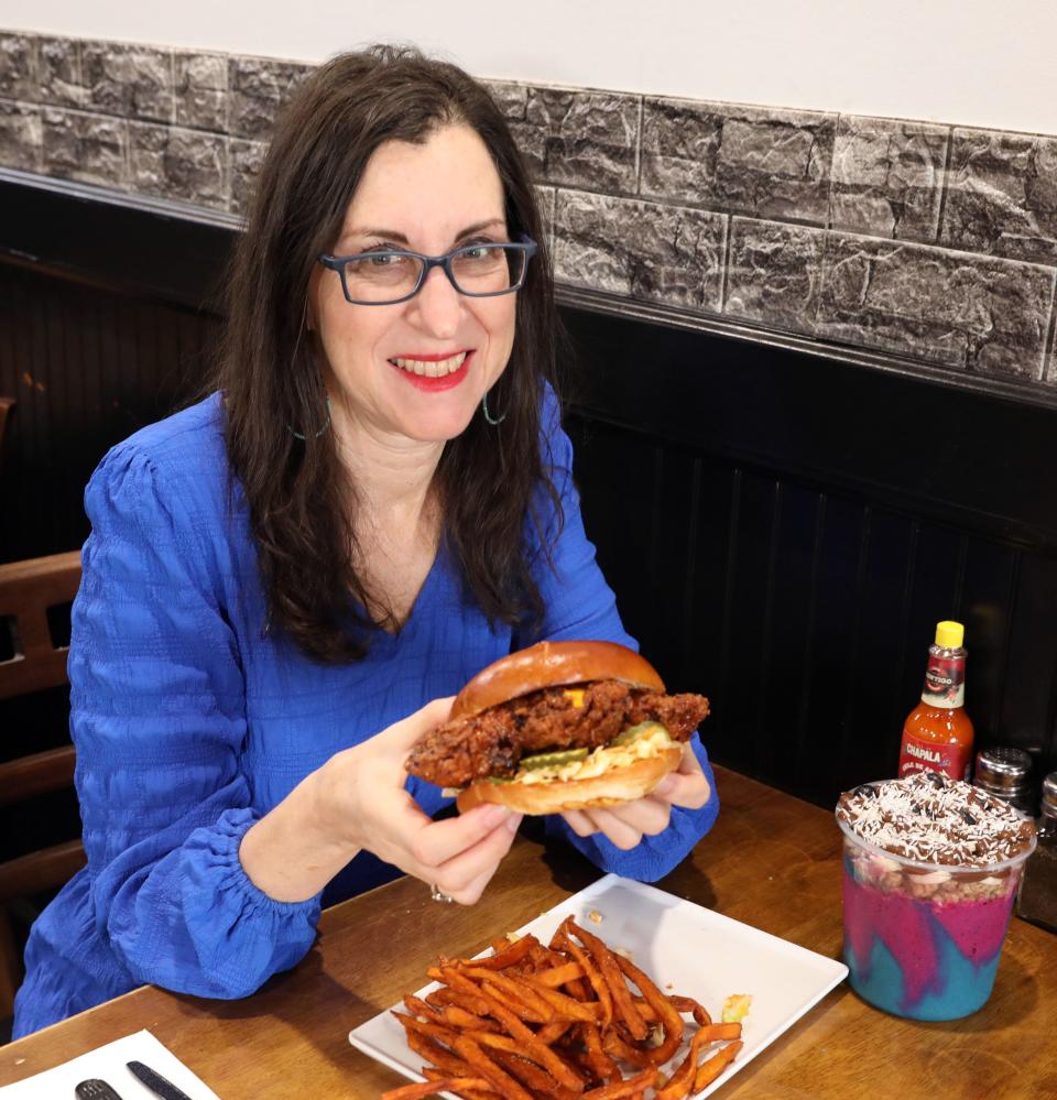 Lohud food and dining reporter Jeanne Muchnick tries the Dave's Hot Chicken Sandwich with sweet potato fries and the Carnival acai bowl at The Peach Pit Bowl Shop & Kitchen in New City March 13, 2024.