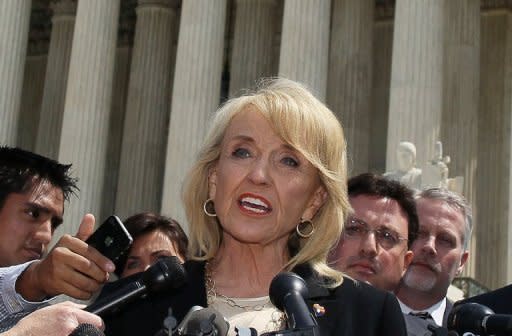 Arizona Governor Jan Brewer speaks to the media after arguments at the U.S. Supreme Court on her state's controversial immigration law