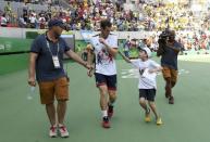 2016 Rio Olympics - Tennis - Preliminary - Men's Singles Second Round - Olympic Tennis Centre - Rio de Janeiro, Brazil - 09/08/2016. Andy Murray (GBR) of United Kingdom reacts as a boy runs on to the court to ask him for an autograph, after he won his match against Juan Monaco (ARG) of Argentina. REUTERS/Kevin Lamarque