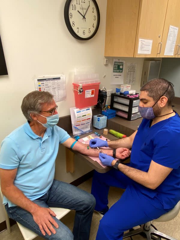 Volunteer prepares to have his blood drawn as part of a Phase 1 clinical trial for a COVID-19 vaccine at Emory University in Atlanta