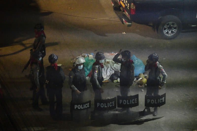 Police officers stand after they seized Sanchaung district in search of anti-coup demonstrators in Yangon