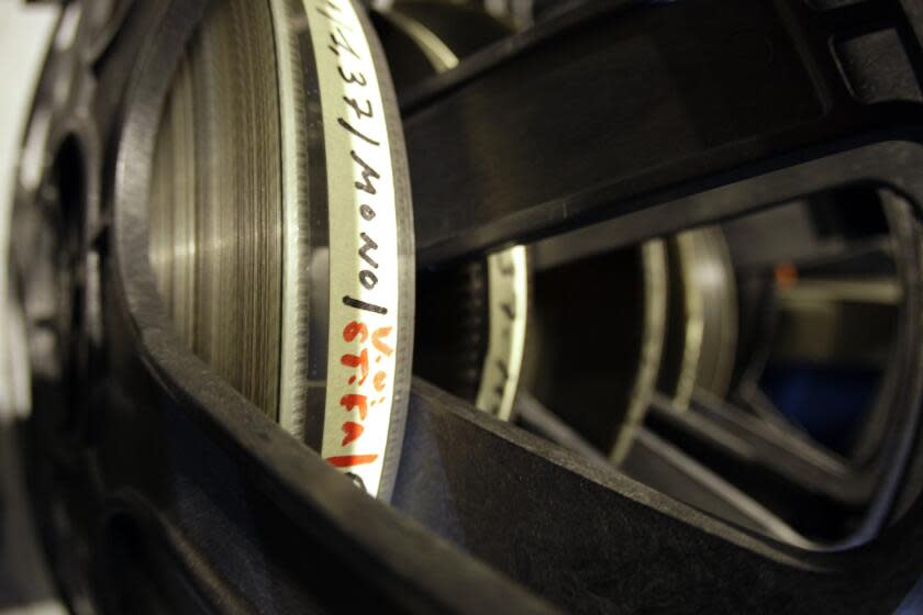 A 35mm feature film is stacked up on its reel in the new projection booth on Piazza Grande, at the 60th International Film Festival Locarno, Friday, August 3, 2007, in Locarno, Switzerland. (KEYSTONE/Martial Trezzini)