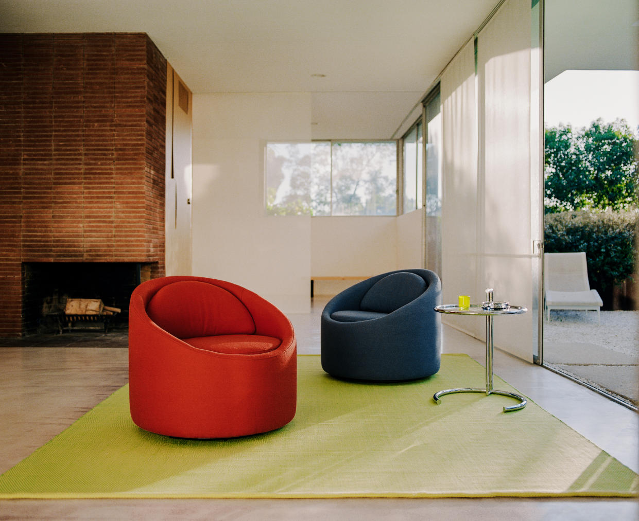  Living room with modern red and black accent chairs. 