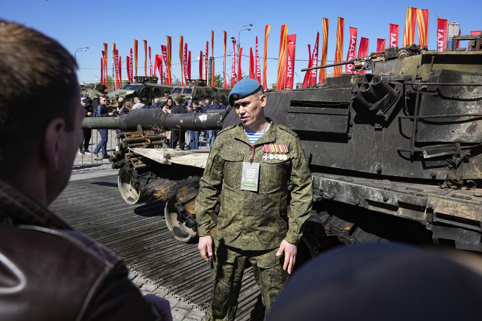 A Russian officer, speaks to foreign military attaches standing at a U.S.-made M1 Abrams tank during their visit an exhibition of Western military equipment captured from Kyiv forces during the fighting in Ukraine, in Moscow on Friday, May 3, 2024. The exhibit organized by the Russian Defense Ministry features more than 30 pieces of Western-made heavy equipment, including a U.S.-made M1 Abrams tank and a Bradley armored fighting vehicle. (AP Photo/Alexander Zemlianichenko)