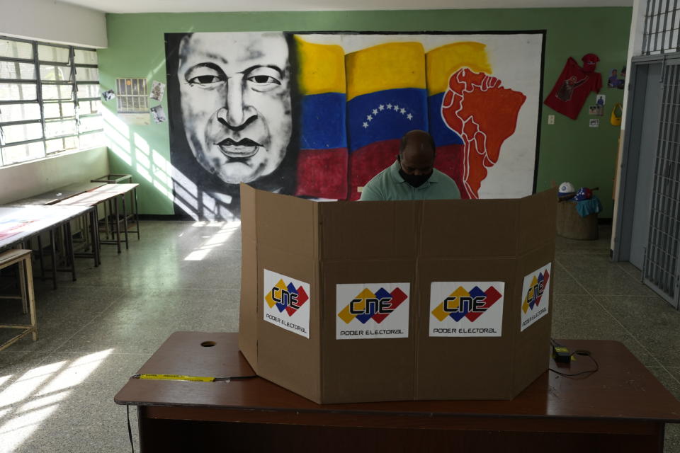A man casts his vote during regional elections, at a polling station in Caracas, Venezuela, Sunday, Nov. 21, 2021. Venezuelans go to the polls to elect state governors and other local officials. (AP Photo/Ariana Cubillos)