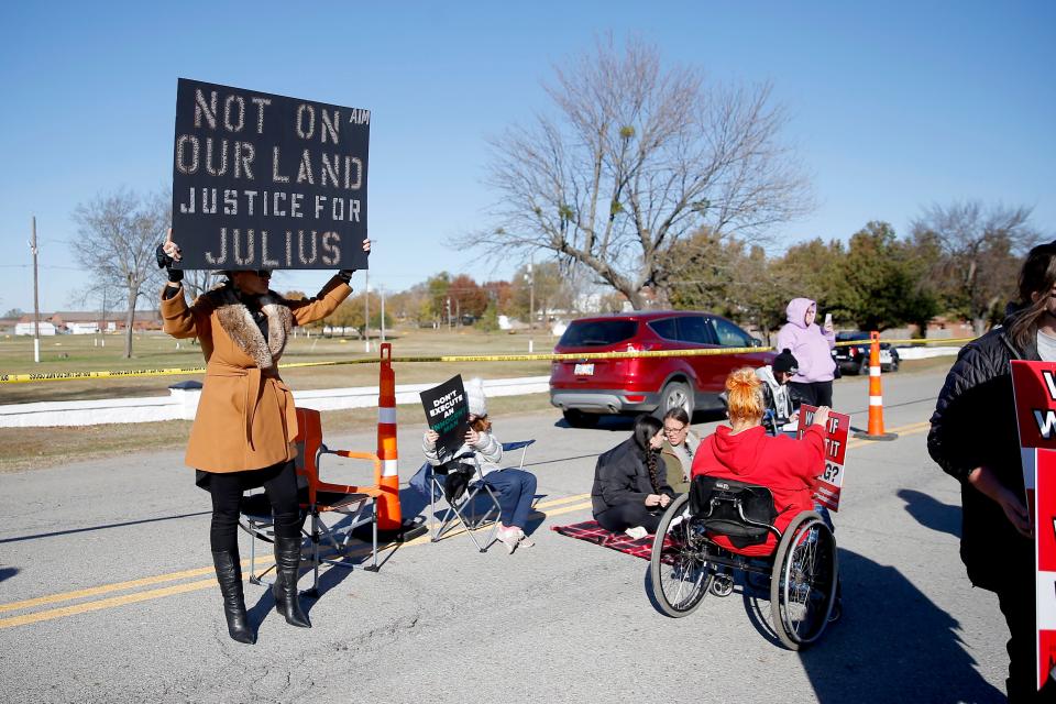 Brandy Foreman, Cherokee, holds a sign outside the Oklahoma State Penitentiary in McAlester, Okla., Thursday, Nov. 18, 2021. Supporters of death row inmate Julius Jones gathered outside the penitentiary before his scheduled execution. 